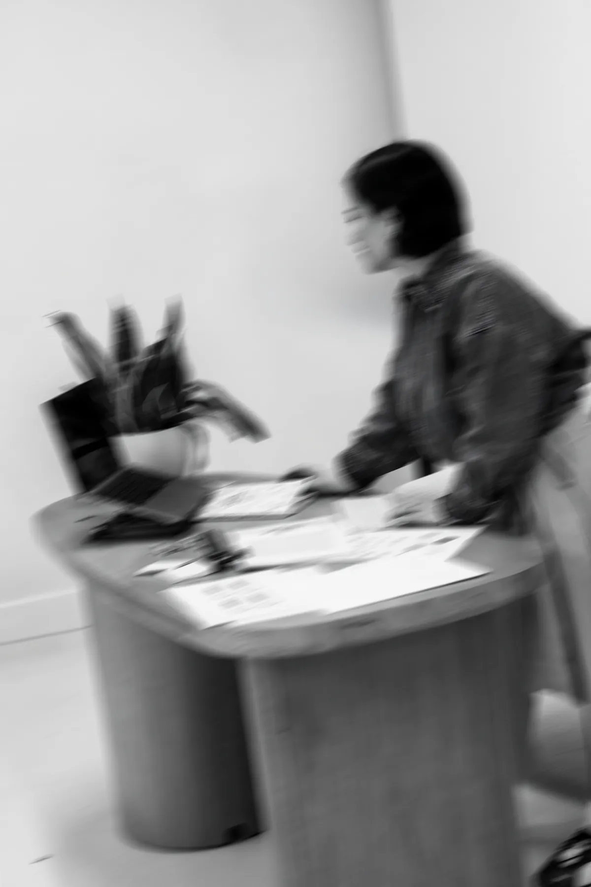 Gabby working at a round table covered in website printouts